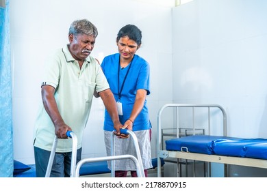 Nurse Helping Recovered Senior Injured Patient To Walk Using Walker At Hospital Ward - Concept Of Professional Occupation, Medicare And Caretaker