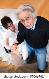 Nurse Helping Senior Man Climbing Stairs