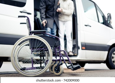 Nurse Helping Senior Man Exit A Van