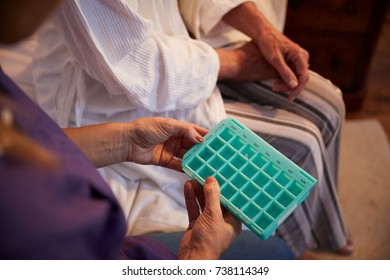 Nurse Helping Senior Woman To Organize Medication On Home Visit