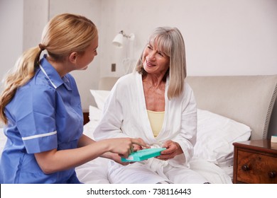 Nurse Helping Senior Woman To Organize Medication On Home Visit