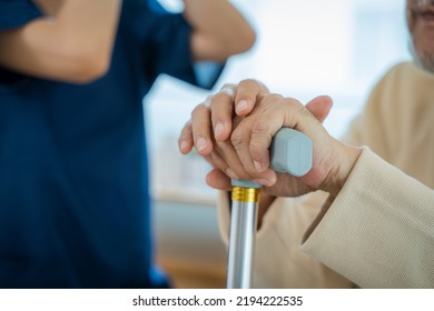 Nurse Helps Senior Man Practice Walking At Nursing Home,Caregiver Serve Physical Therapy For Older Patient To Exercise And Practice Walking On Walker Or Cane. 