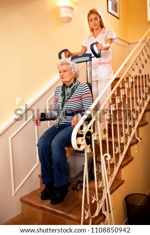 Similar – Caregiver making bed of elderly patient in nursing home