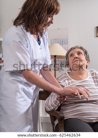 Similar – Caregiver helping elderly female patient to get out of bed