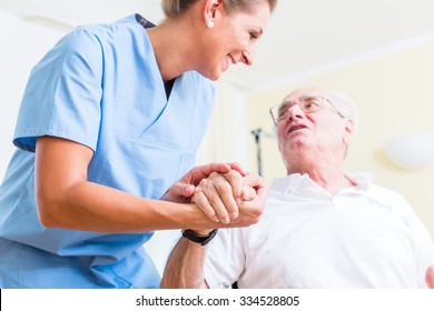 Nurse holding hand of senior man in rest home - Powered by Shutterstock