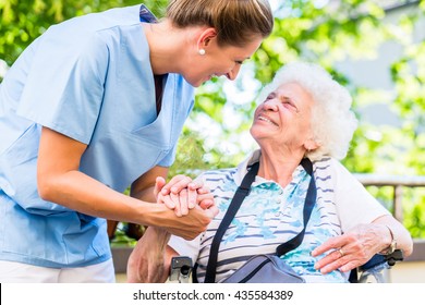 Nurse holding hand of senior woman in pension home