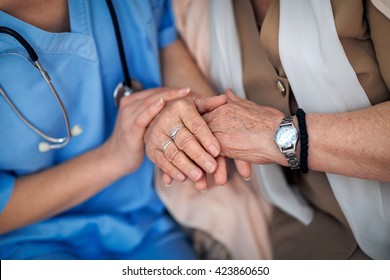 Nurse Holding A Hands To Elderly Woman