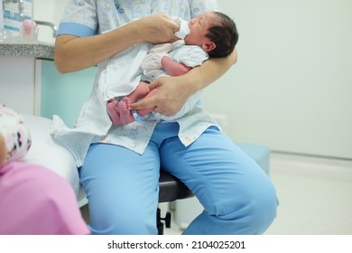 Nurse Holding Newborn Baby In Maternity Ward, Hospital. 