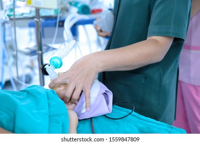 Nurse Holding Oxygen Mask For A Child Patient. General Anesthesia Before Cardiac Surgery