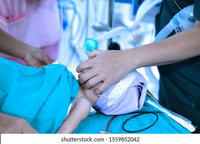 Nurse Holding Oxygen Mask For A Child Patient. General Anesthesia Before Cardiac Surgery In Operating Room