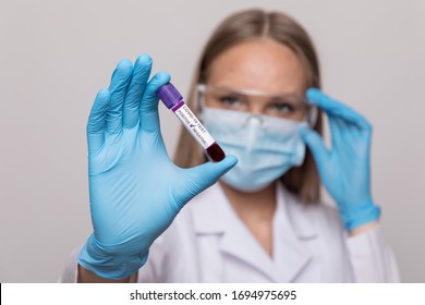 Nurse Holding Test Tube With Blood For 2019-nCoV Analyzing. Coronavirus Positive Blood Test Concept