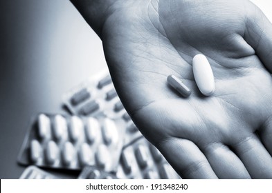 Nurse Holding Two Pills In Hand