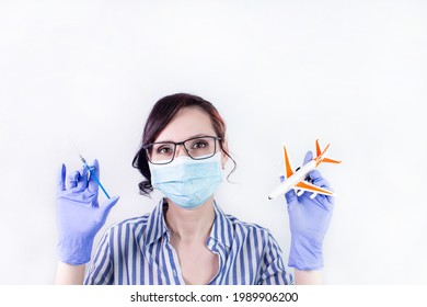 Nurse Holding Vaccine Syringe And Airplane Model, Vaccination Against The Virus Covid-19. Vaccination Against Covid-19 For Traveling