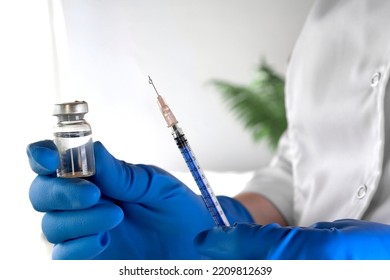 Nurse Holds A Syringe And Vaccine Bottle In His Hand Close Up. Doctor Ready To Give An Injection. Science. Medical Cosmetology, Beauty Treatment, Skin Care Concept. Covid 19, Monkeypox Vaccination.