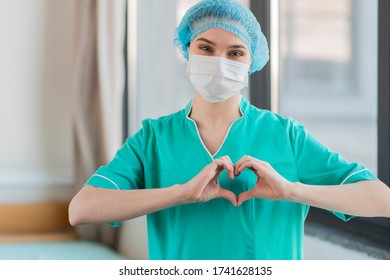 A nurse at the hospital shows a heart - Shutterstock ID 1741628135