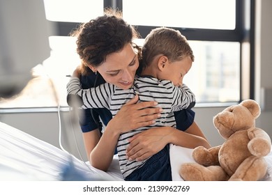 Nurse hugging sick little boy patient in hospital. Young medical practitioner embracing upset kid in clinic. Lovely doctor taking care of cute child at private clinic: gratitude and healthcare concept