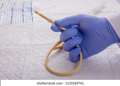 Nurse inflates urinary catheter bulb with leg drainage bag on sterile field.