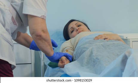 Nurse Leaving Female Patient With Drip To Rest