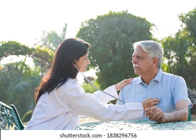 Nurse listening to heartbeat of old patient