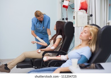 Nurse Looking After A Blood Donor In Hospital Ward, Healthcare Workers In The Coronavirus Covid19 Pandemic