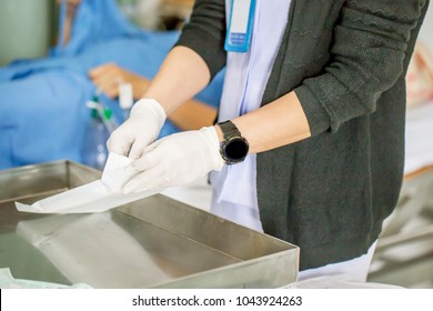 
The Nurse With Lots Of Medicine Is Preparing Or Cleaning The Stitch Of Her Woman Patient After Surgery In The Patient Department In The Hospital , Grainy Style With Intention
