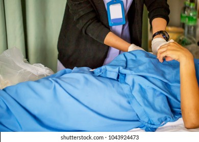 
The Nurse With Lots Of Medicine Is Preparing Or Cleaning The Stitch Of Her Woman Patient After Surgery In The Patient Department In The Hospital , Grainy Style With Intention
