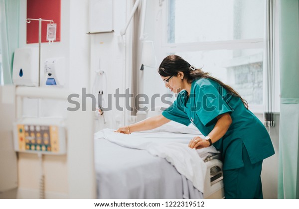 Nurse making the bed at a\
hospital