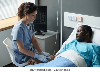 Nurse making dropper for elderly patient - Powered by Shutterstock