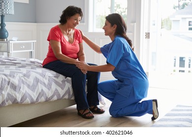 Nurse Making Home Visit To Senior Hispanic Woman