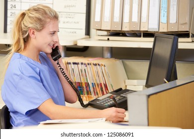 Nurse Making Phone Call At Nurses Station