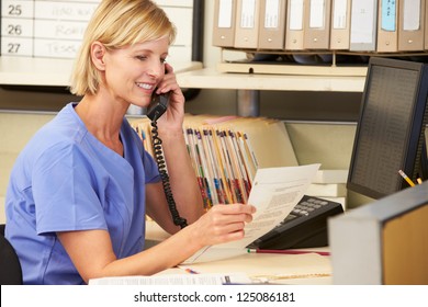 Nurse Making Phone Call At Nurses Station