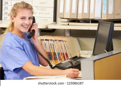 Nurse Making Phone Call At Nurses Station