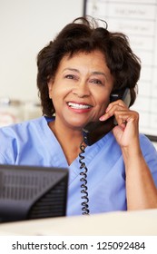 Nurse Making Phone Call At Nurses Station