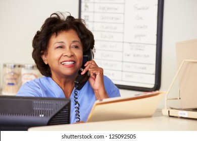 Nurse Making Phone Call At Nurses Station