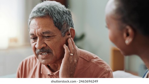 Nurse, man and hearing aid on ear for medical support, wellness and innovation of disability. People, healthcare worker and deaf patient with audiology implant, service or help for sound waves - Powered by Shutterstock