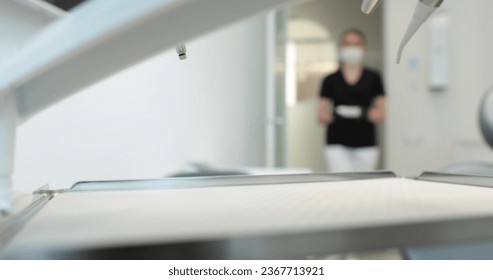 A nurse in a mask carries a tray with disinfected instruments to start a dental surgery. Dentistry and dental treatment in a state-of-the-art clinic. - Powered by Shutterstock