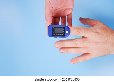 A Nurse Measures A Man's Pulse With A Pulse Oximeter.Measurement, Monitoring Of Pulse Rate, Blood Oxygen Saturation, Lung Testing For Viral Infection, Cardio Test.Copyspace