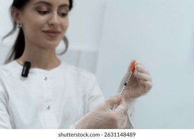 A nurse in medical gloves holds a syringe, ready for administering a vaccination in a healthcare facility during daytime hours