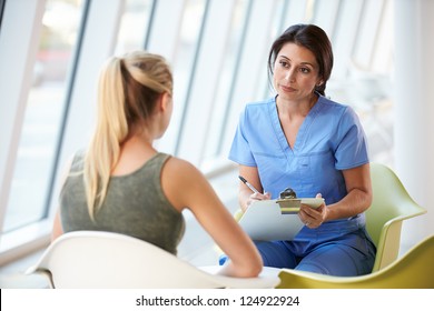 Nurse Meeting With Teenage Girl In Modern Hospital