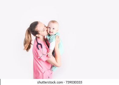 Nurse mom with baby boy dressed up in scrubs