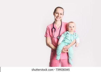 Nurse Mom With Baby Boy Dressed Up In Scrubs