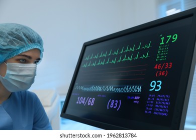 Nurse Near Monitor With Cardiogram In Hospital