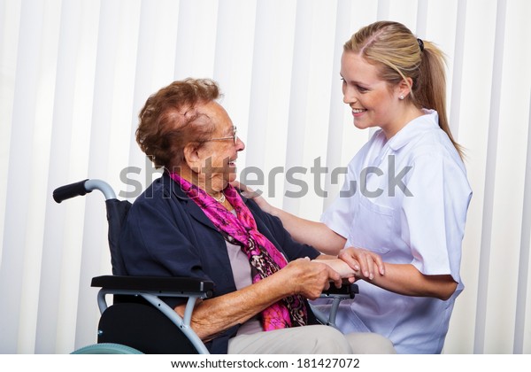 a nurse and an\
old woman in a wheelchair.