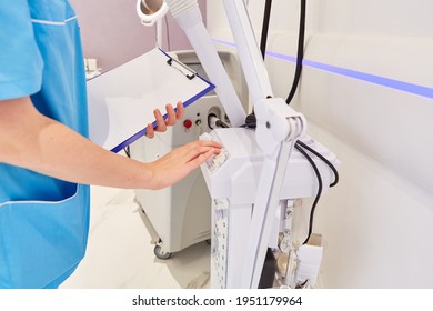 Nurse Operates A Medical Device In The Beauty Clinic