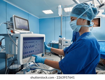 Nurse in operating room of hospital checking patient's vital signs while surgical operation. Surgical department - Powered by Shutterstock