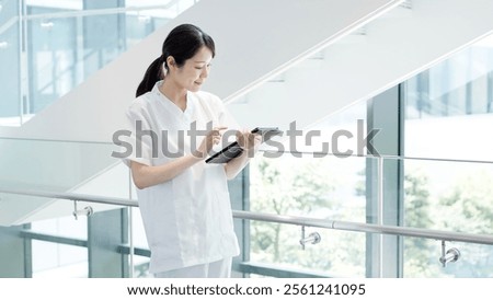 A nurse operating a tablet