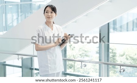 A nurse operating a tablet