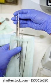 Nurse Packs A Dental Instrument Before Its Sterilization In A Dental Clinic - Concept Of Modern Technology In Medicine                  