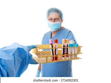 Nurse or pathologist hands patient blood tests to another laboratory worker.  Blood tubes include gel, clot, edta and citrate for various blood testing and diagnosis