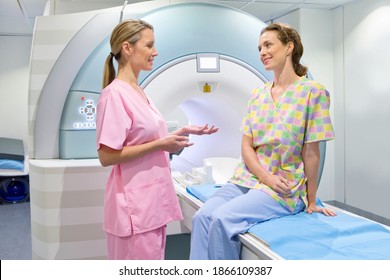 A nurse and a patient discussing at the MRI scan machine in the hospital